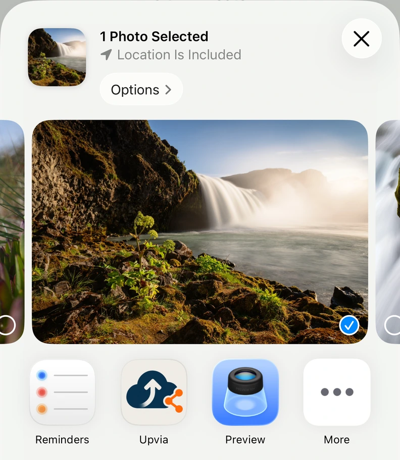 The iOS share sheet showing a selected photo and Upvia in the app row.
